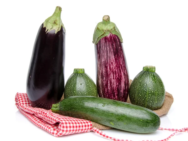 Eggplants and a zucchini on a burlap bag — Stock Photo, Image