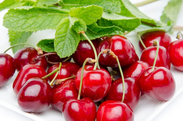 Fresh red cherries with mint — Stock Photo, Image