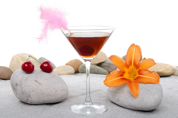 Cocktail de cereja em um ambiente de areia e pedras de seixos — Fotografia de Stock