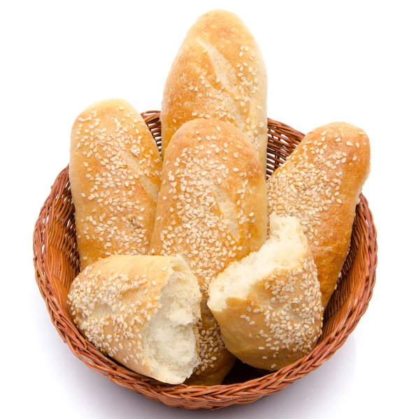 Sesame buns whole and broken in a basket — Stock Photo, Image