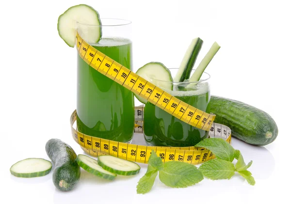 Composition with cucumber juice, fresh cucumbers and a tape meas — Stock Photo, Image