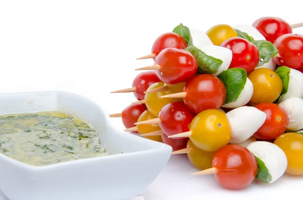 Kirschtomaten und Mozzarella auf Spießen und Vinaigrette-Sauce — Stockfoto