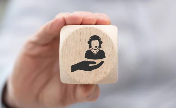 顧客サービスの概念の象徴と木製のキューブを保持手 — ストック写真
