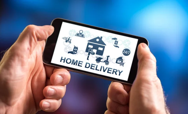 Hand holding a smartphone with home delivery concept
