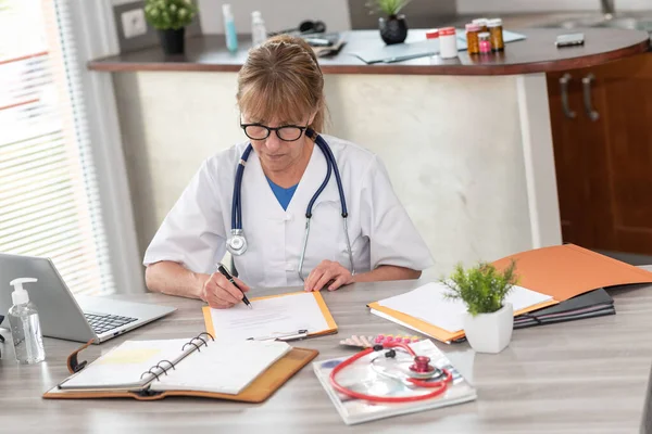 Female Doctor Reading Clinical Record Medical Office — Stock Photo, Image