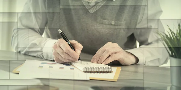 Businessman working on financial results and taking notes on notepad, geometric pattern