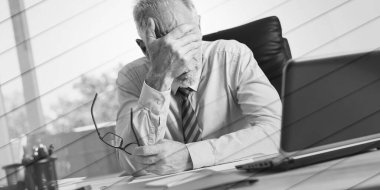 Portrait of stressed businessman sitting in office, geometric pattern