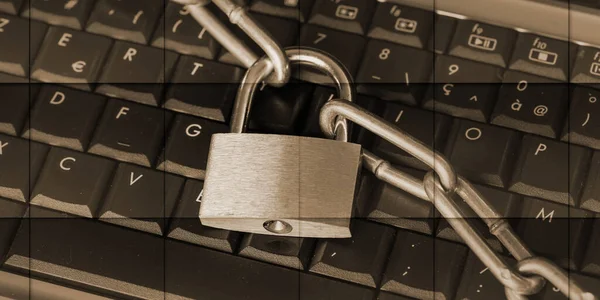 Computer security concept with a padlock and a chain on a keyboard, geometric pattern