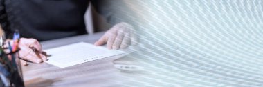 Businessman reviewing terms of contract at office; panoramic banner