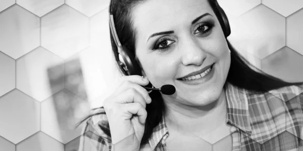 Young beautiful woman with headset working from home, geometric pattern