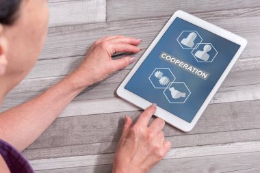 Woman using a tablet showing cooperation concept