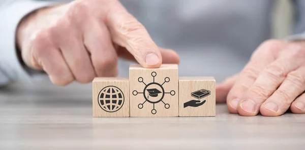 Wooden blocks with symbol of knowledge sharing concept