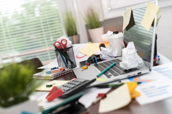 Messy and cluttered office desk