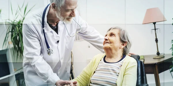 Male Doctor Supporting Elderly Woman Nursing Home Geometric Pattern —  Fotos de Stock