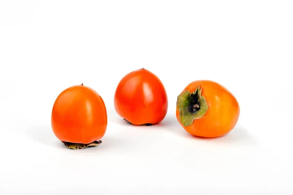 Three Ripe Persimmon Fruits White Background — Zdjęcie stockowe