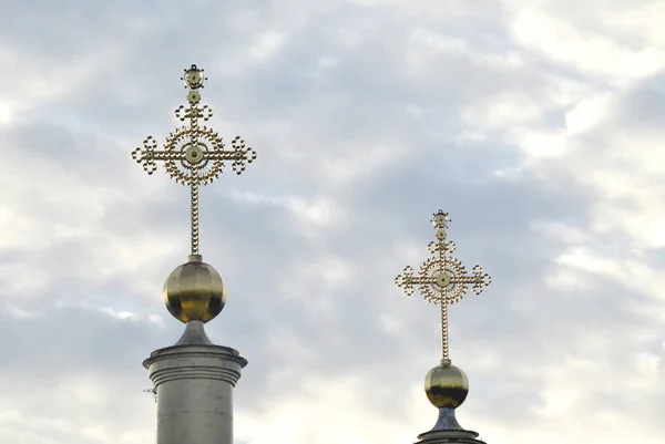 Golden crosses on the background of clouds