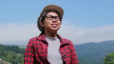 Kasklı kadın mühendis doğa ile çevrili güzel bir kırsalda çalışıyor ve dağda yeni proje planları hayal ediyor..