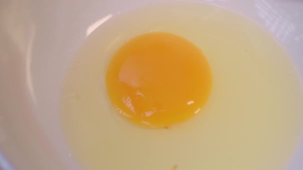 Close Hand Cracking Egg White Bowl Reveals Yolk Cooking Breakfast — Stock Video