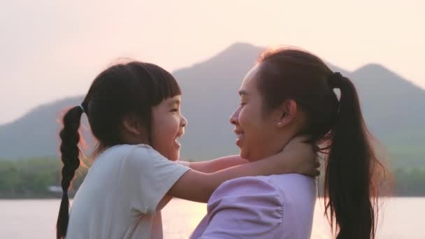 Madre Sosteniendo Una Linda Hijita Caminando Por Lago Atardecer Niña — Vídeos de Stock