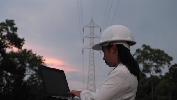 Asian Female Electrical Engineer Working Laptop High Voltage Pole Inspecting — Video