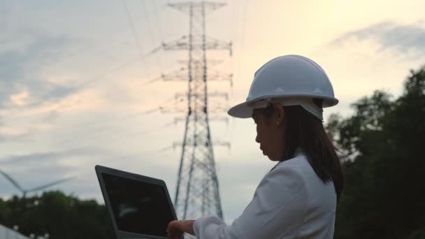 Asian Female Electrical Engineer Working Laptop High Voltage Pole Inspecting — Video