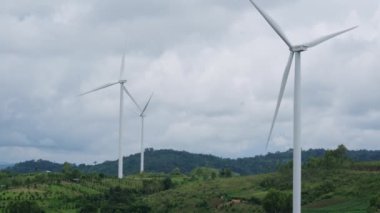 Panoramic view of wind turbines or wind farm with beautiful landscapes and blue sky to generate clean renewable green energy for sustainable development. Windmills for electric power production.