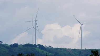 Panoramic view of wind turbines or wind farm with beautiful landscapes and blue sky to generate clean renewable green energy for sustainable development. Windmills for electric power production.
