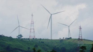 Panoramic view of wind turbines or wind farm with beautiful landscapes and blue sky to generate clean renewable green energy for sustainable development. Windmills for electric power production.