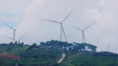 Panoramic view of wind turbines or wind farm with beautiful landscapes and blue sky to generate clean renewable green energy for sustainable development. Windmills for electric power production.