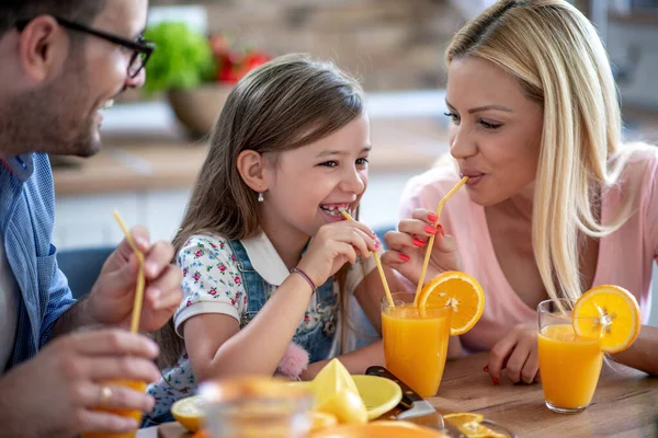 Happy Family Mother Father Daughter Drinking Juice Home — Foto de Stock