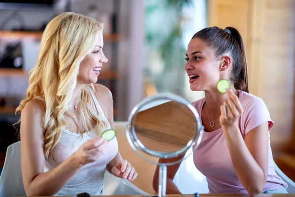 Two Women Holding Pieces Cucumber Faces — Stock Photo, Image