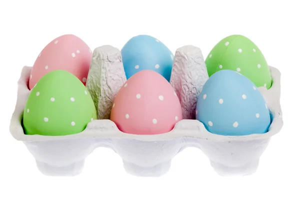 Pastel colored easter eggs in cardboard, isolated — Stock Photo, Image