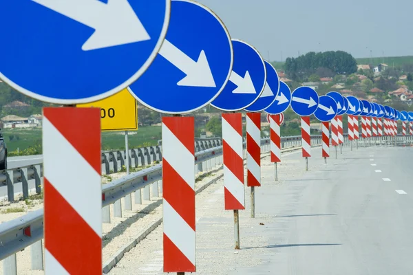 A lot of road signs showing directions — Stock Photo, Image