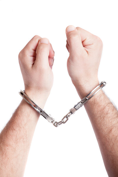 closeup of the hands of a man with handcuffs