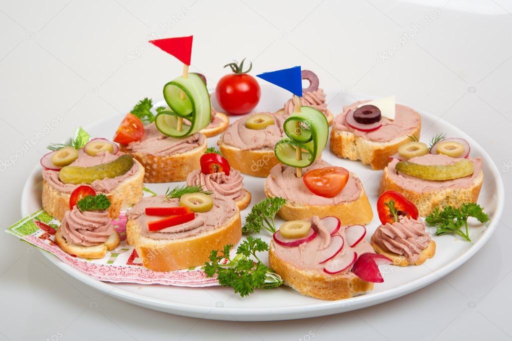 party platter with sandwiches with pate and vegetables