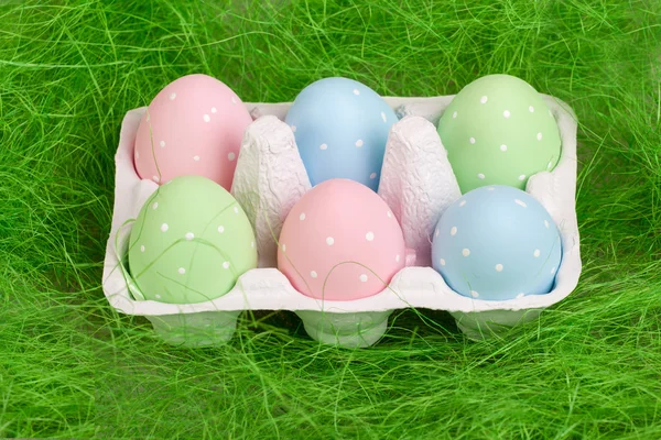 Pastel colored easter eggs in cardboard — Stock Photo, Image