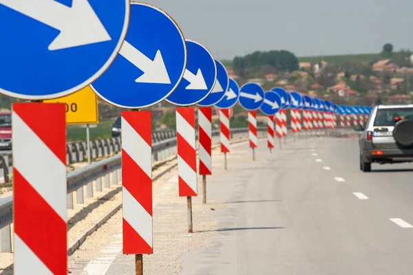 A lot of road signs showing directions — Stock Photo, Image