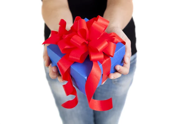 Blue gift box with red ribbon in woman hands — Stock Photo, Image