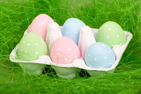 Pastel colored easter eggs in cardboard — Stock Photo, Image