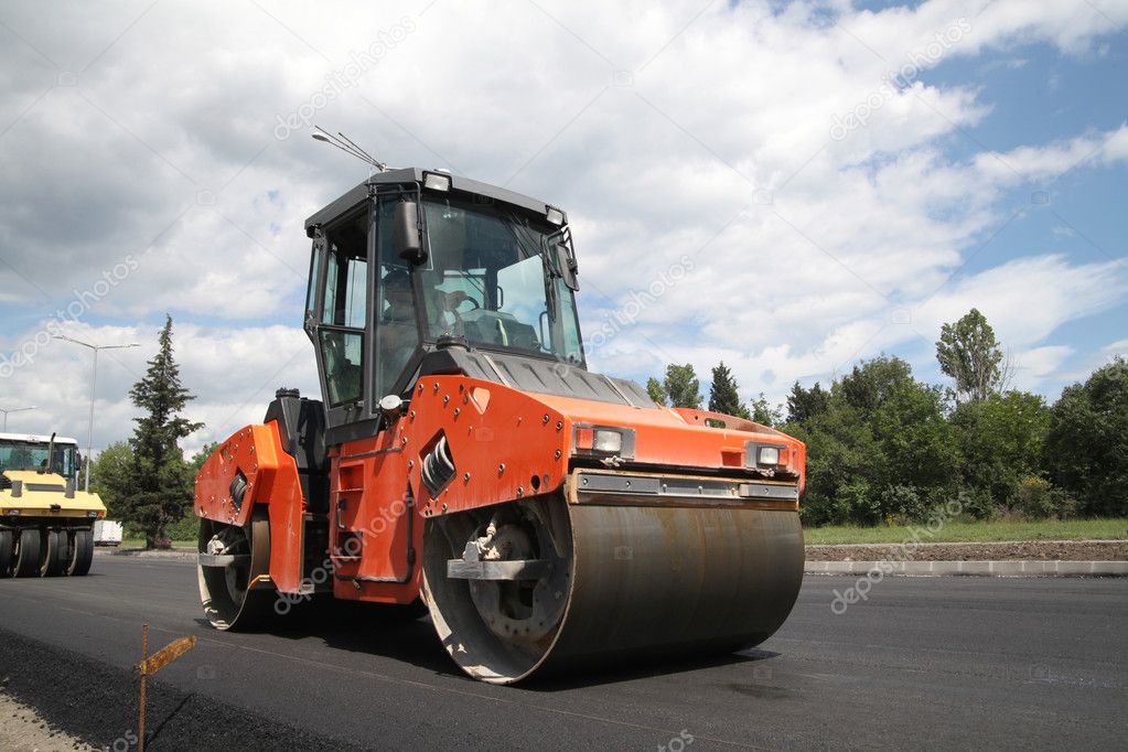 Large road-roller paving a road. Road construction