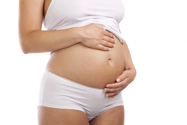 Pregnant woman touching her belly with hands — Stock Photo, Image