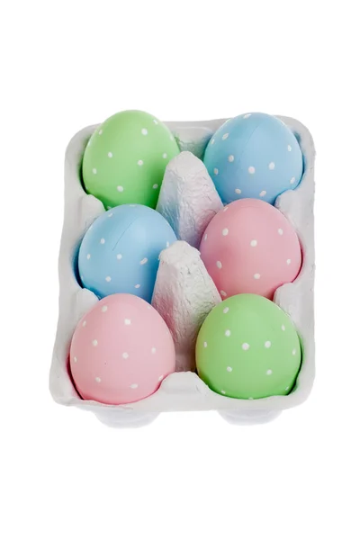 Pastel colored easter eggs in cardboard, isolated — Stock Photo, Image