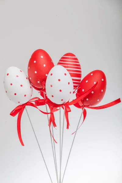 Red and white decorative easter eggs with ribbons — Stock Photo, Image