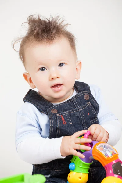 Cute smiling baby with fancy haircut in studio — Stock Photo, Image