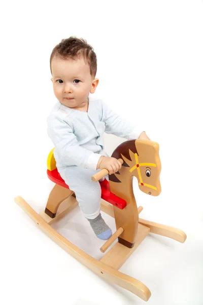 Chłopczyk na koń na biegunach. — Zdjęcie stockowe