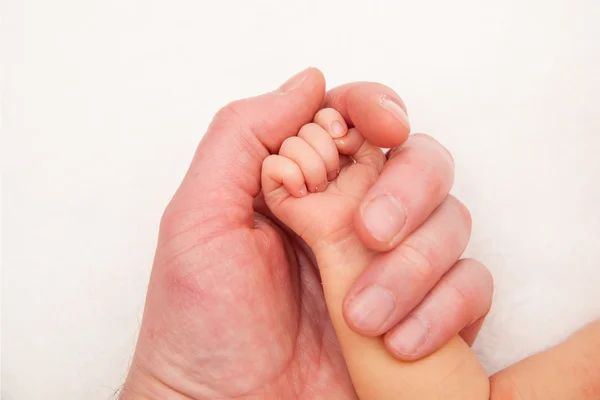 Holding a hand of the newborn child — Stock Photo, Image