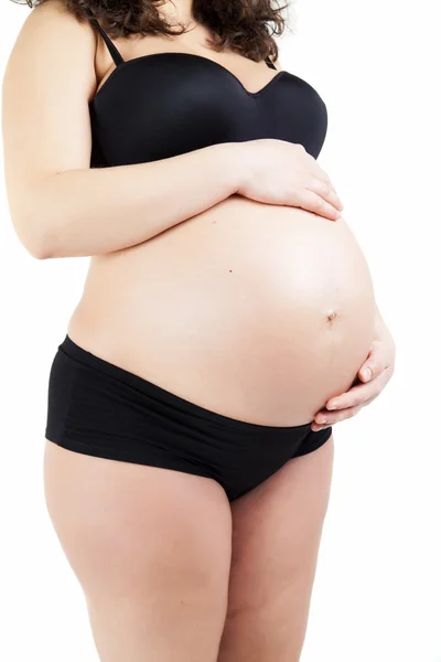 Donna incinta che tocca il ventre con le mani — Foto Stock