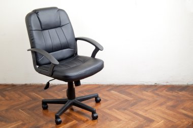 Black leather office chair in room