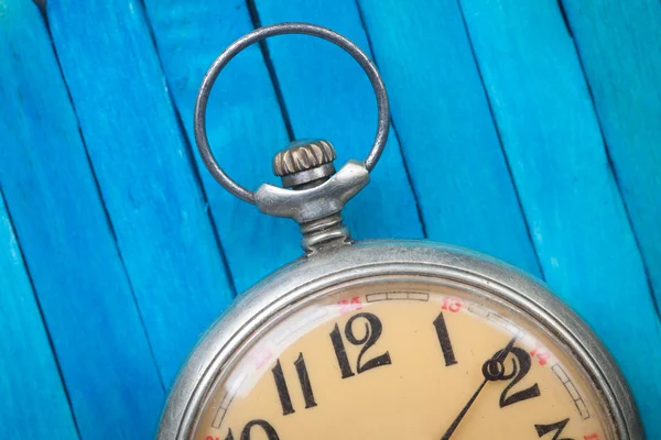 Primer plano de reloj de bolsillo de estilo antiguo en fondo de madera azul — Foto de Stock