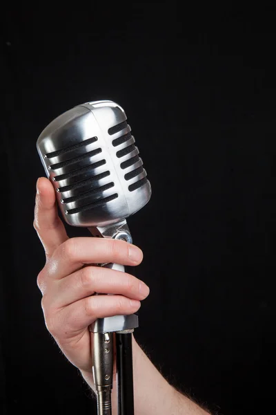 Hand holding a retro microphone — Stock Photo, Image